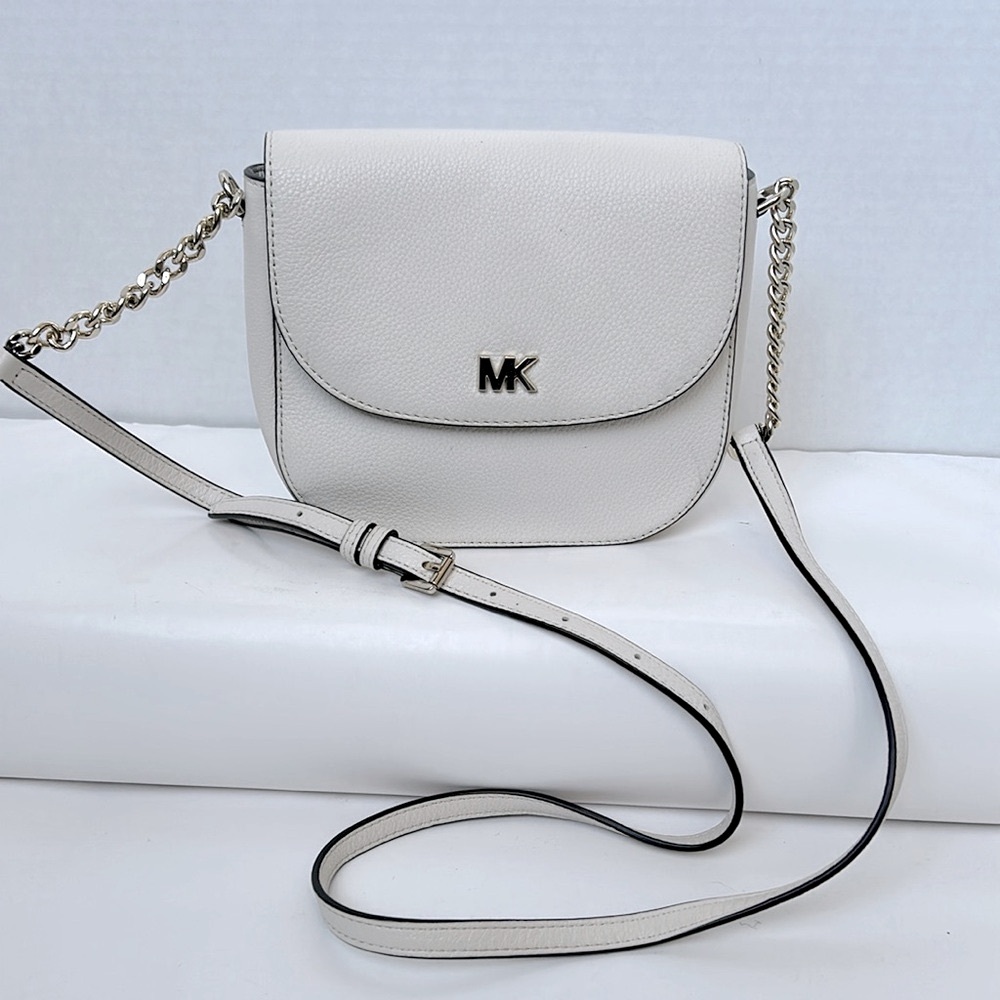 MICHAEL KORS light cream color crossbody bag with adjustable strap.